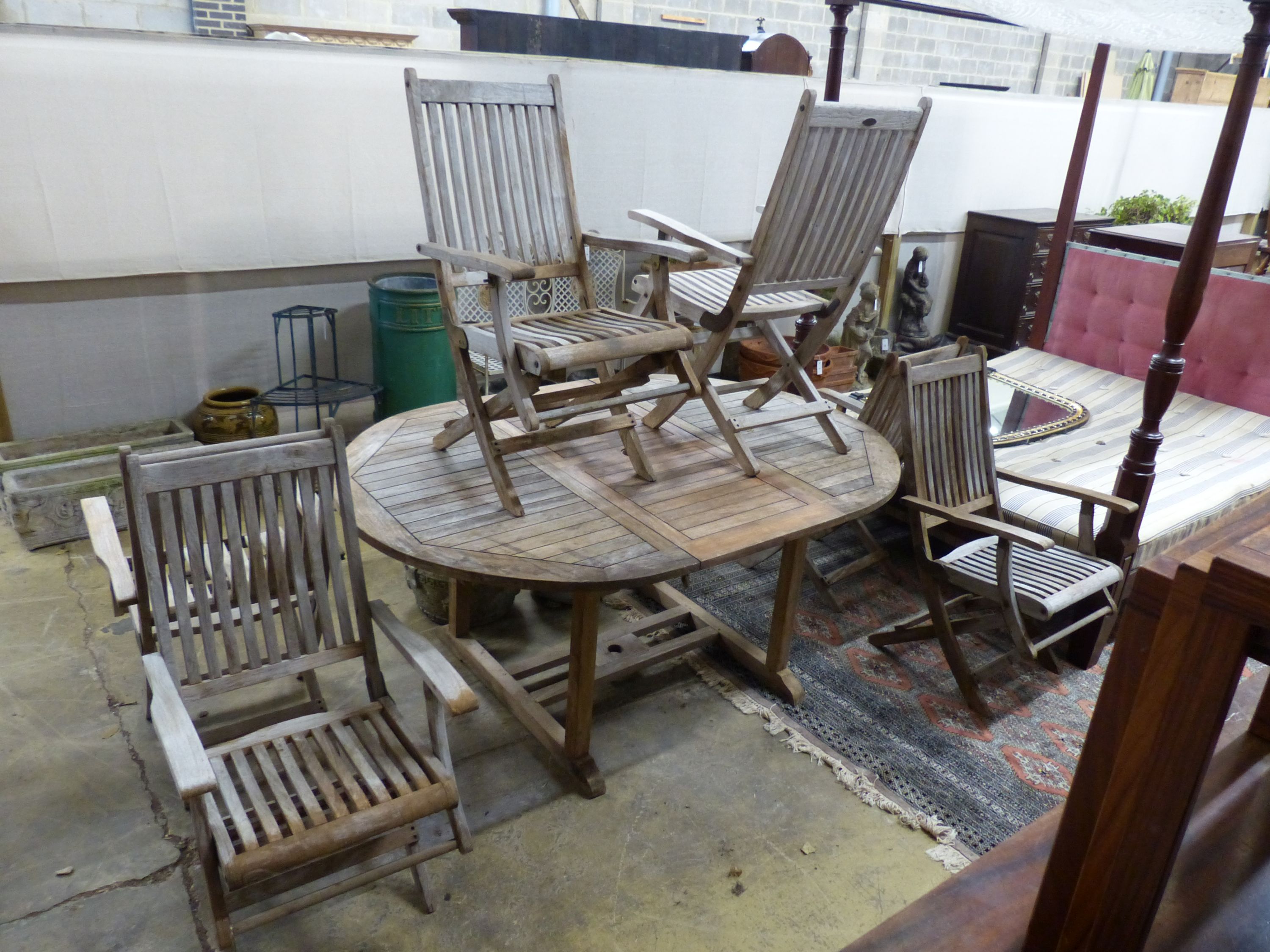 A 'Westminster' extending teak garden table, length 171cm and a set of six folding chairs
